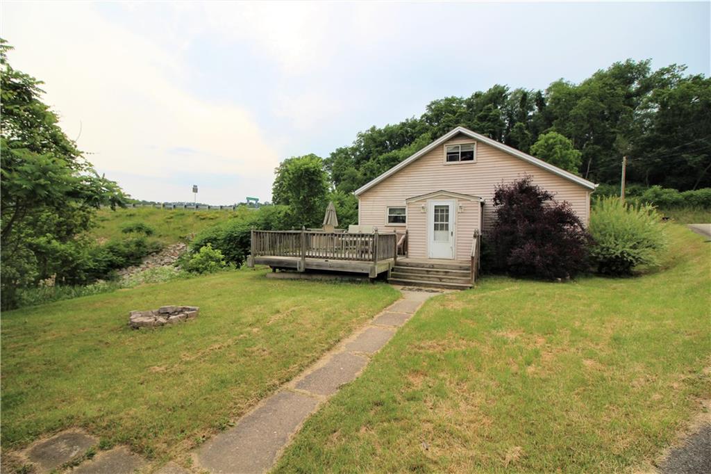 1456 Rte 481 Charleroi, PA 15022 - Photo 6 of 25 Side Yard has a Fire Pit & Concrete Sidewalk that leads to Man Door of Detached Garage.