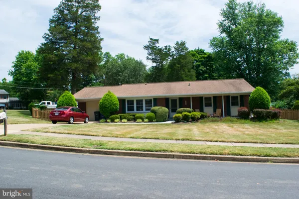 a view of a house with a garden and pathway