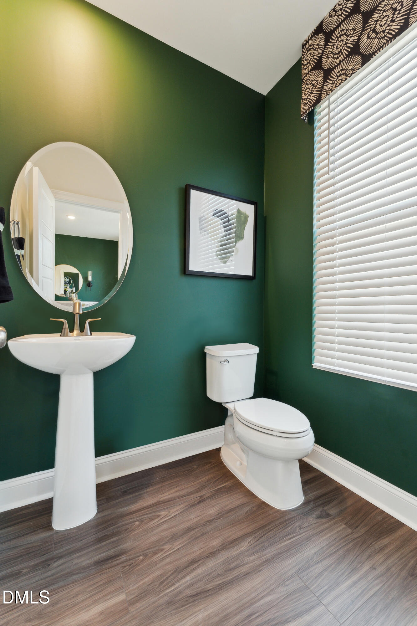 10610 Pleasant Branch Drive Raleigh, NC 27614 - Photo 10 of 34 a bathroom with a toilet sink and mirror
