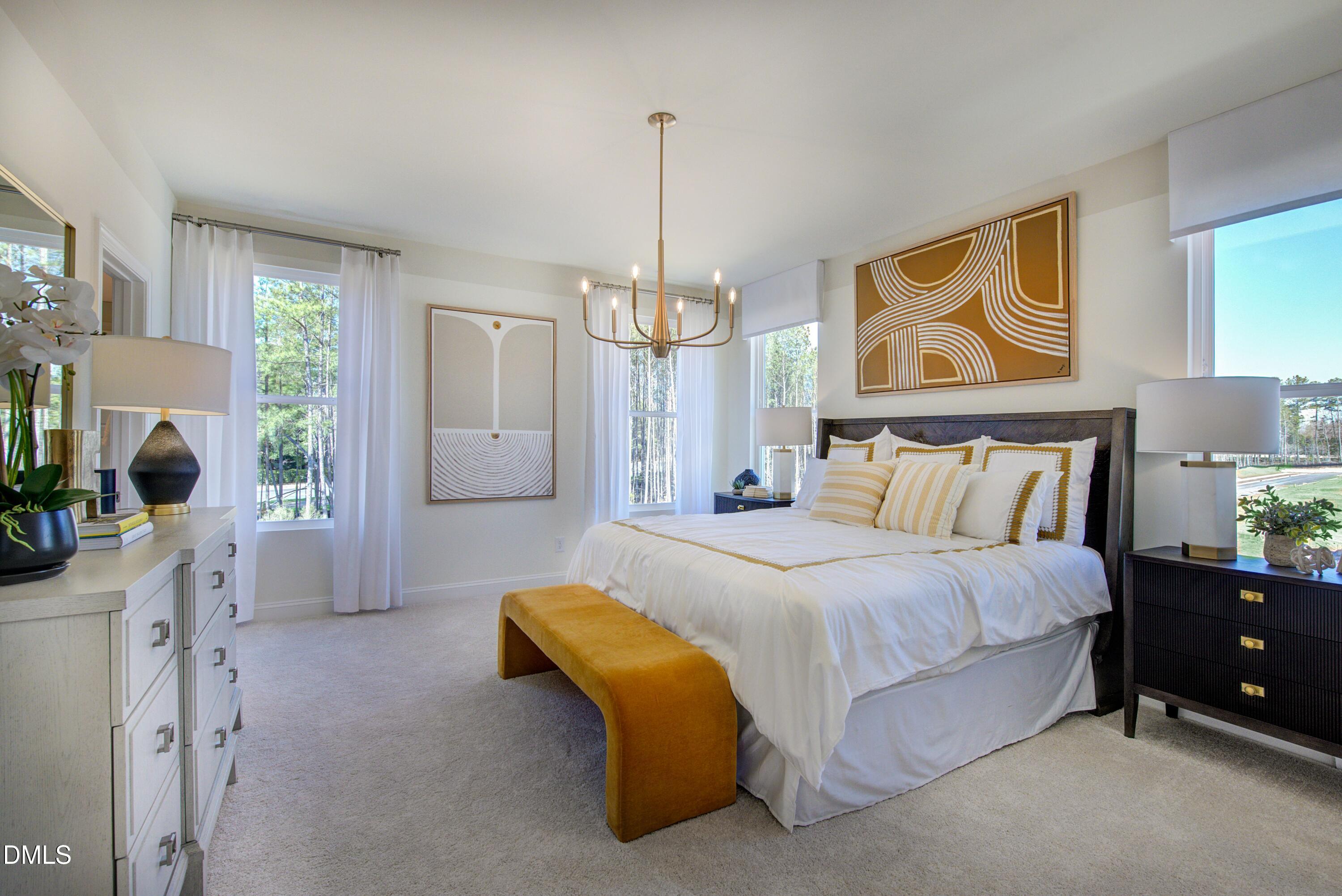 10610 Pleasant Branch Drive Raleigh, NC 27614 - Photo 11 of 34 a spacious bedroom with a bed and a chandelier