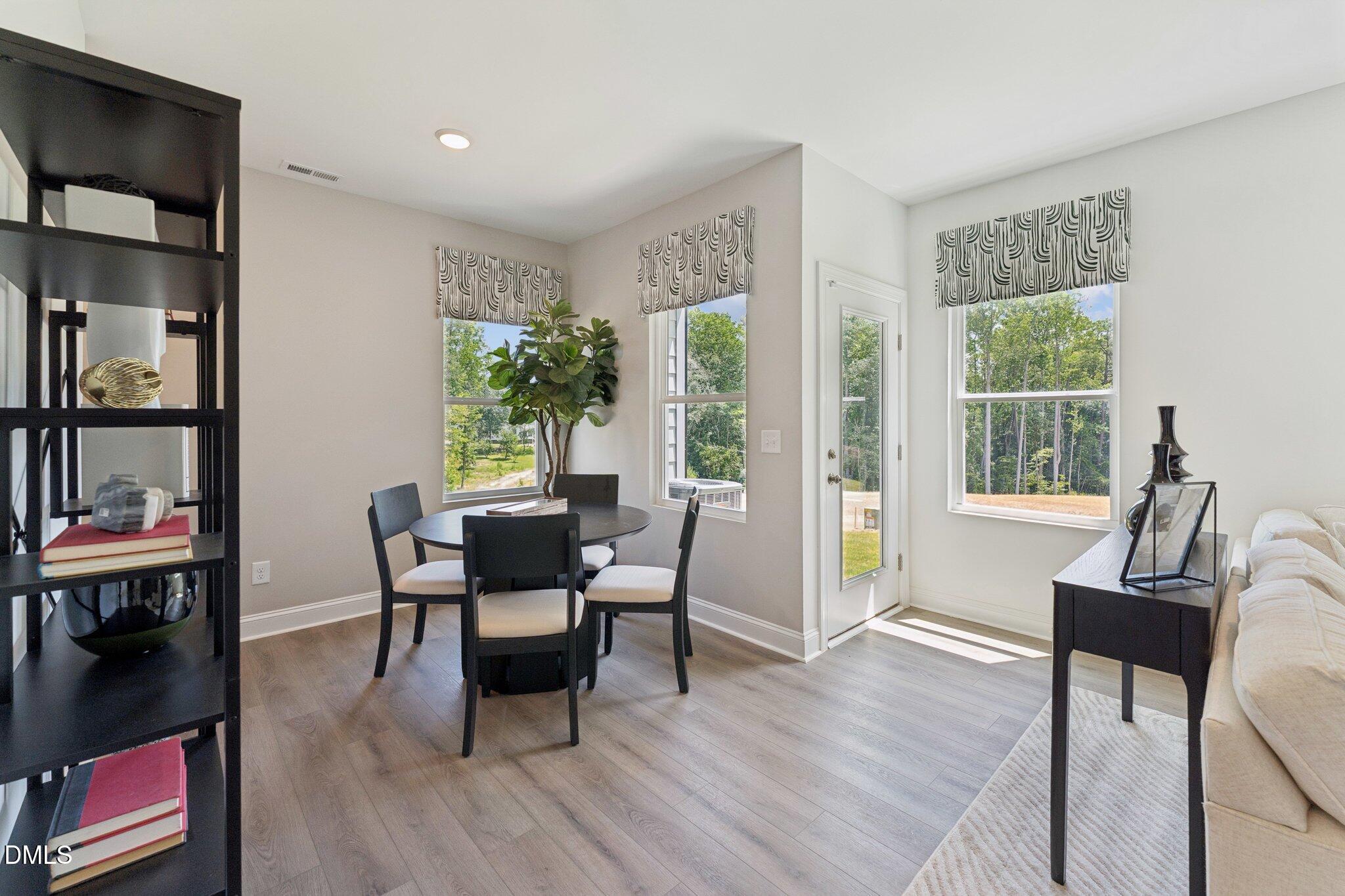 10610 Pleasant Branch Drive Raleigh, NC 27614 - Photo 20 of 34 a dining room with furniture window and wooden floor
