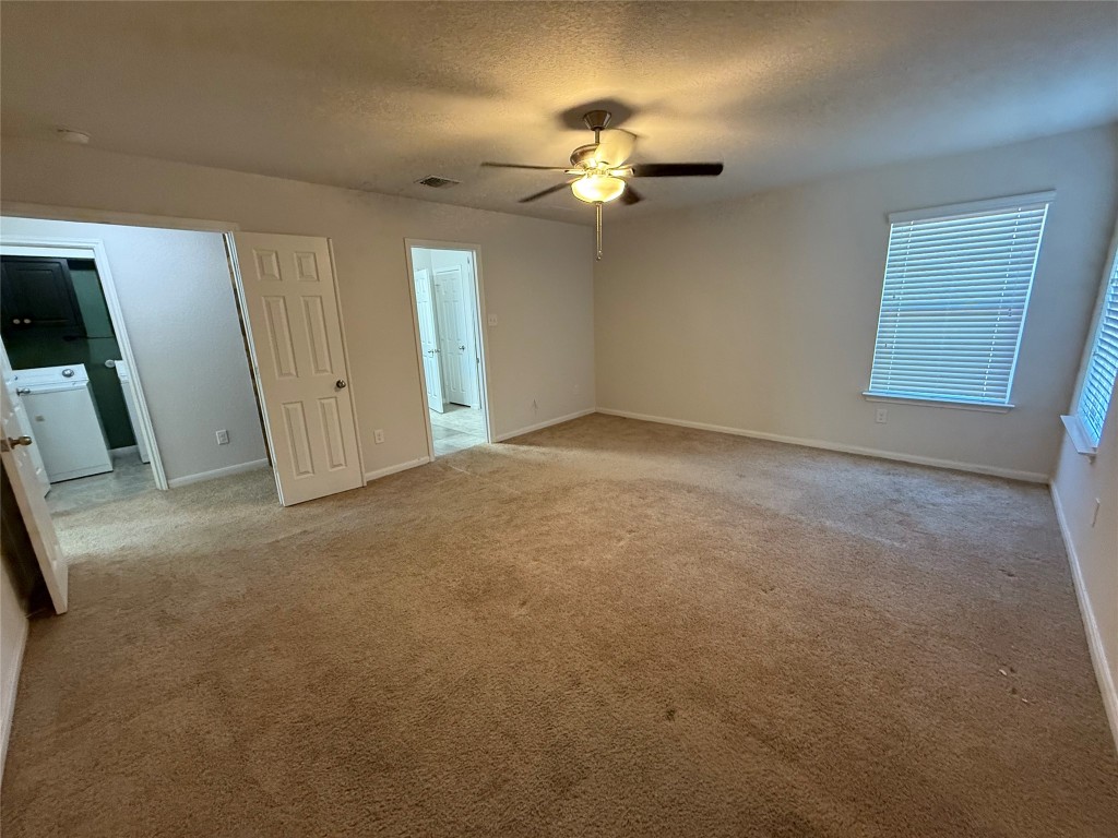206 Windridge Drive North Lockhart, TX 78644 - Photo 11 of 20 a view of an empty room with a chandelier fan