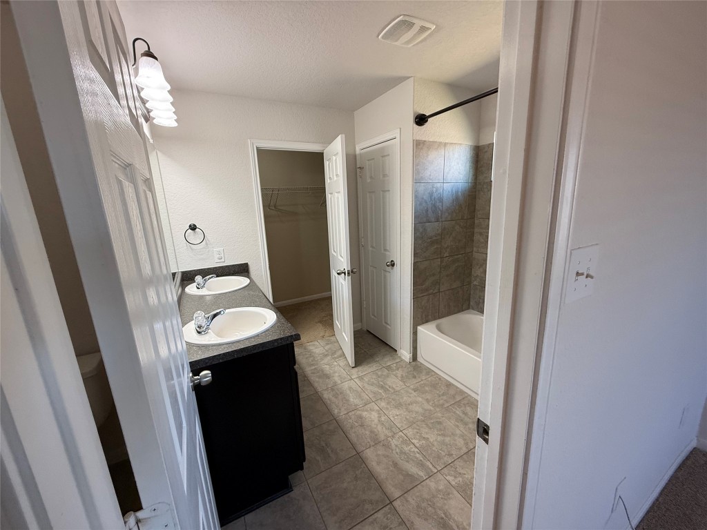 206 Windridge Drive North Lockhart, TX 78644 - Photo 13 of 20 a bathroom with a sink a toilet and shower