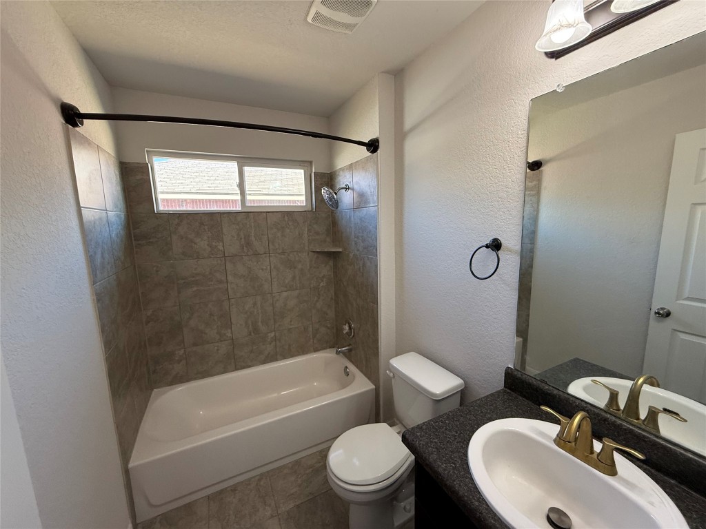 206 Windridge Drive North Lockhart, TX 78644 - Photo 18 of 20 a bathroom with a sink toilet and shower