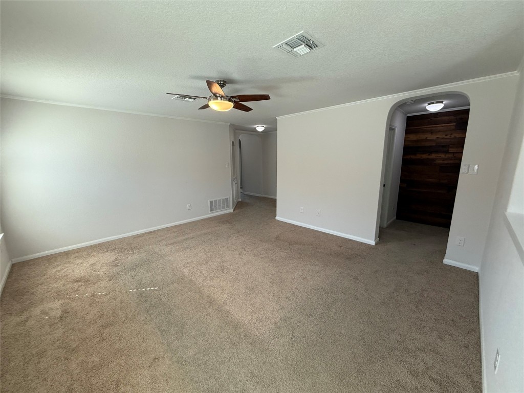 206 Windridge Drive North Lockhart, TX 78644 - Photo 4 of 20 an empty room with a mirror and a ceiling fan