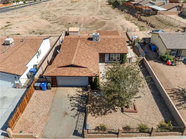 an aerial view of a house with a yard