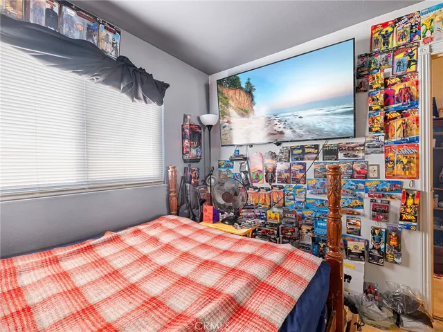 a bed room with a bed and a television