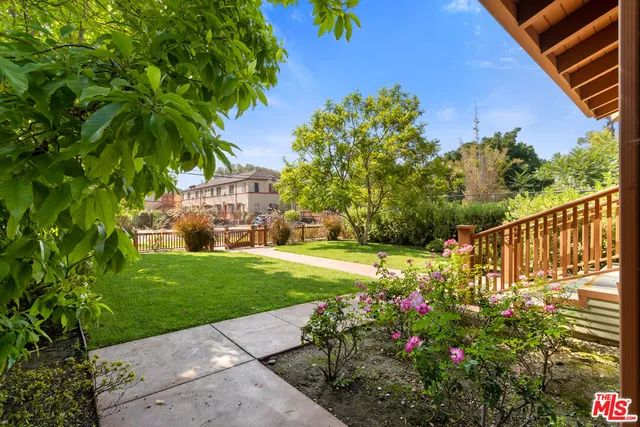 a view of a pathway with a flower garden