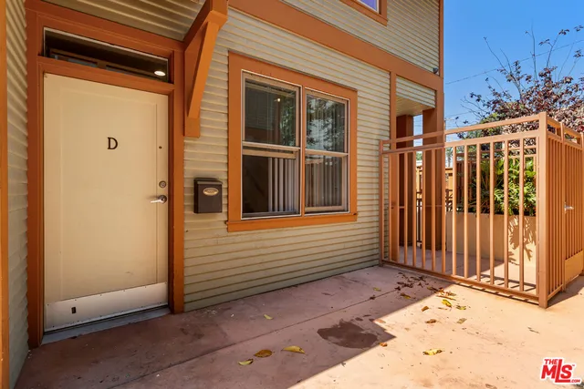 a view of a house with a wooden fence