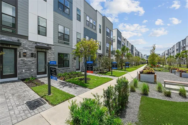 a view of a building with a yard and plants