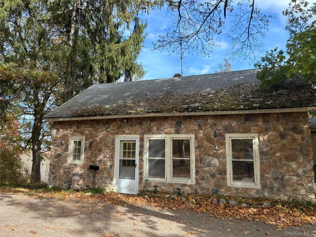 front view of a house with a tree