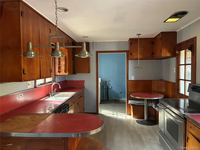 a kitchen with a sink appliances and cabinets