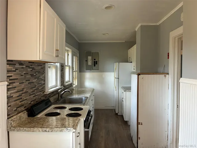 a kitchen with a refrigerator sink and stove