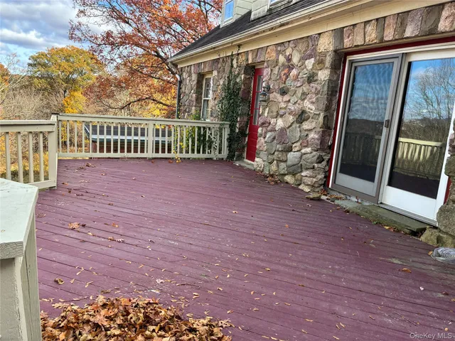 a view of a porch with a floor to ceiling window next to a yard