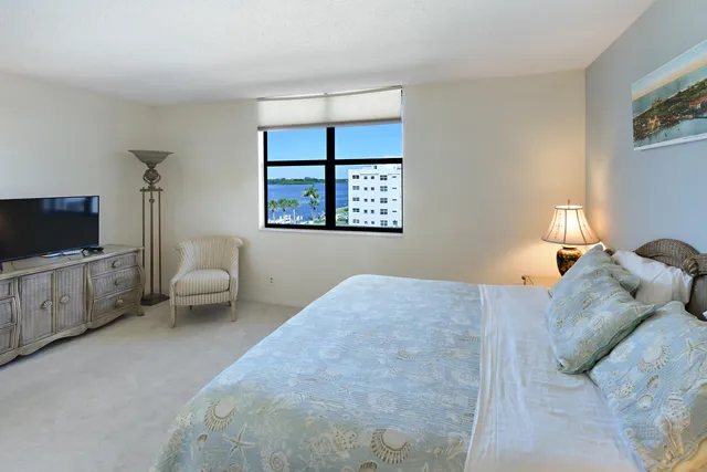 a bedroom with a large bed and a flat screen tv