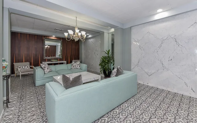 a living room with furniture and a chandelier