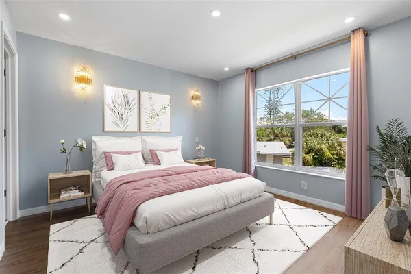 a bedroom with a large bed and a large window