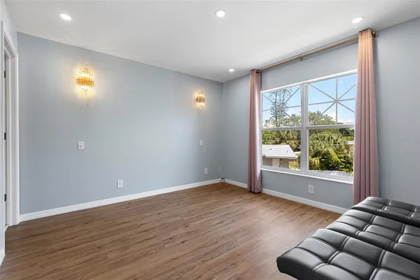 a view of room with window and wooden floor