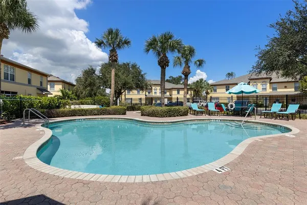 a view of a swimming pool with outdoor seating