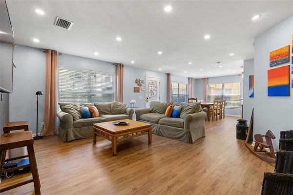 a living room with furniture and wooden floor
