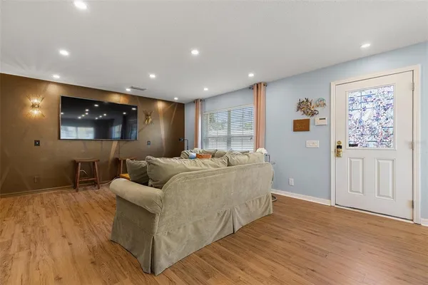 a living room with furniture and a wooden floor
