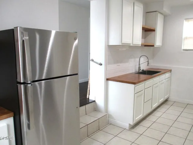 a white refrigerator freezer sitting in a kitchen