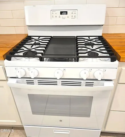 a view of a room with an empty space and a window