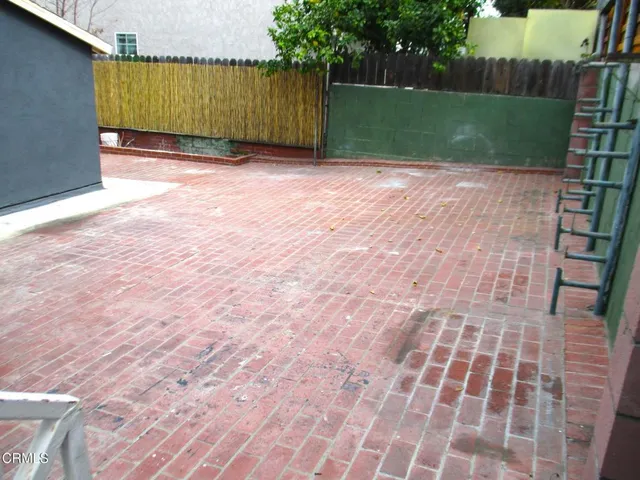 a backyard of a house with table and chairs