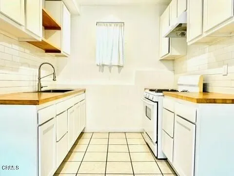 a utility room with sink dryer and washer