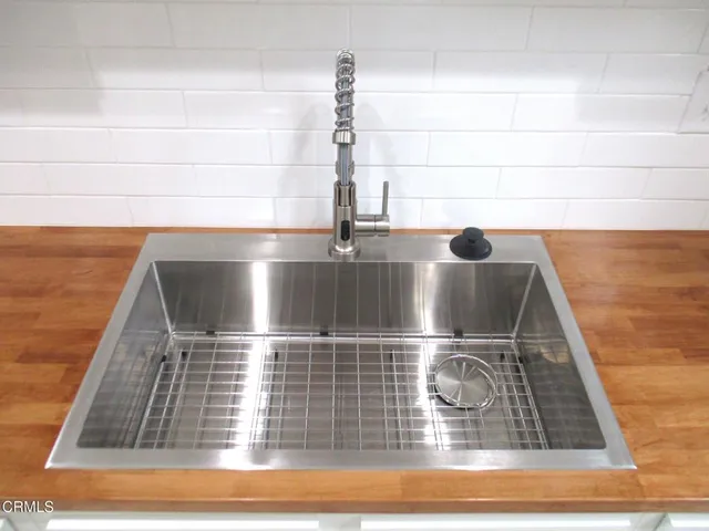 a kitchen with a refrigerator sink and cabinets