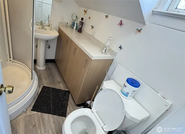 a bathroom with a sink toilet and shower