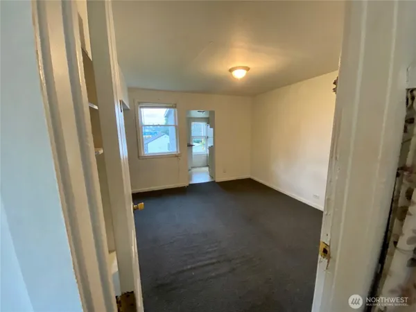 a view of an empty room and a window