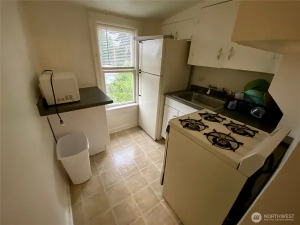 a kitchen with a stove and a refrigerator