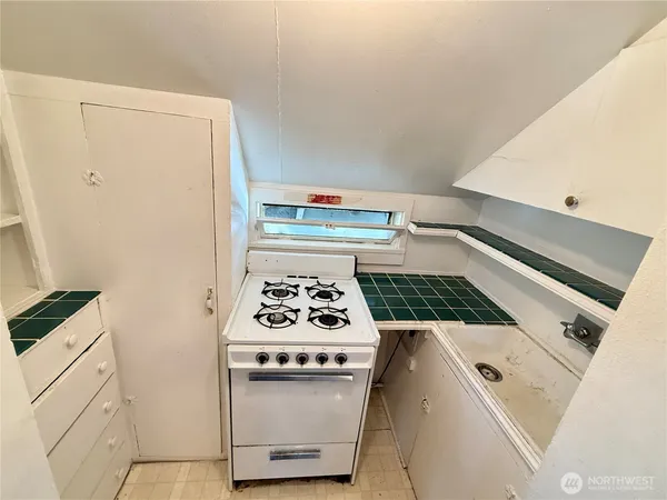 a white stove top oven sitting inside of a kitchen