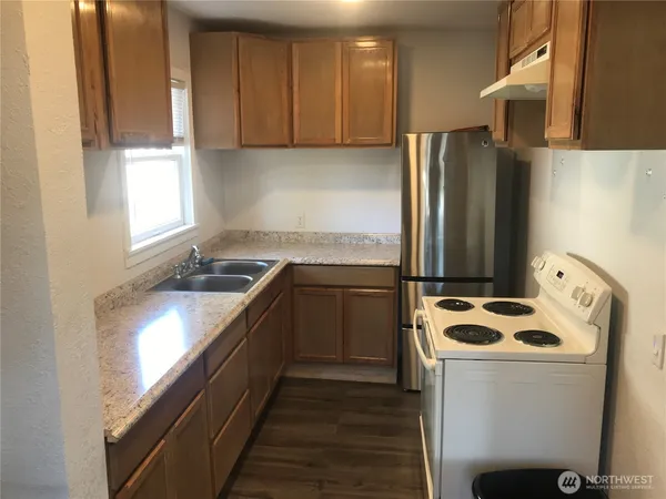 a kitchen with stainless steel appliances a refrigerator sink and cabinets