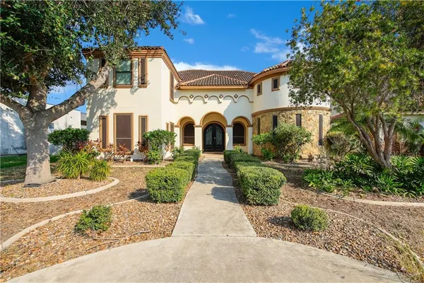 a front view of a house with garden