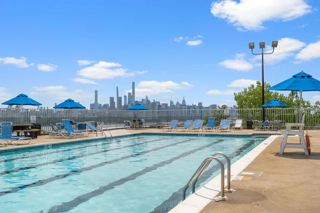 a view of a swimming pool and lounge chairs