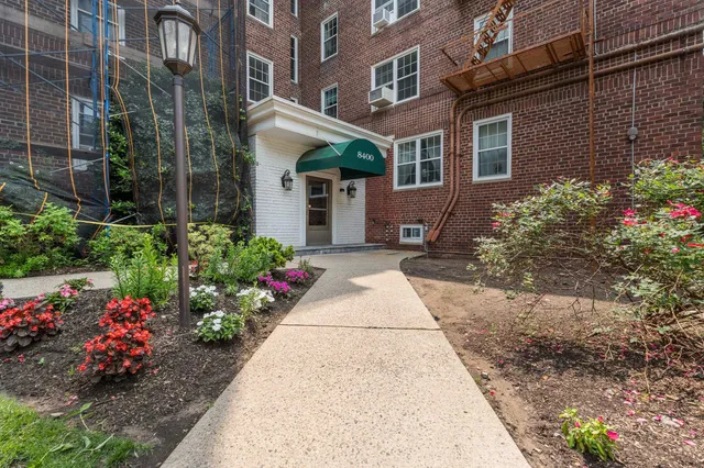 a view of a house with a yard and garden