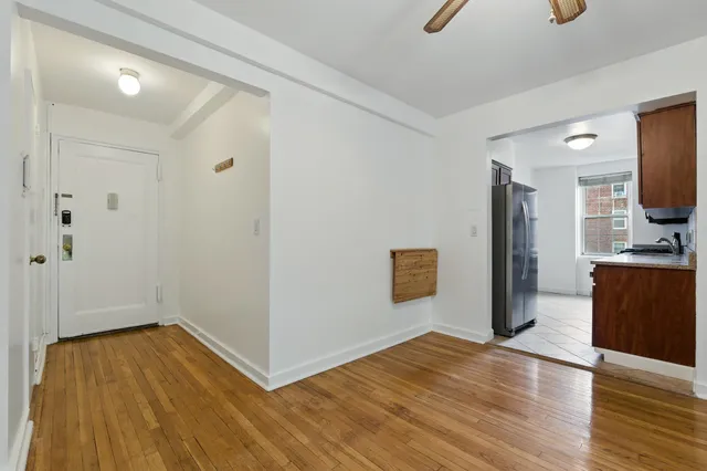 a view of empty room with wooden floor