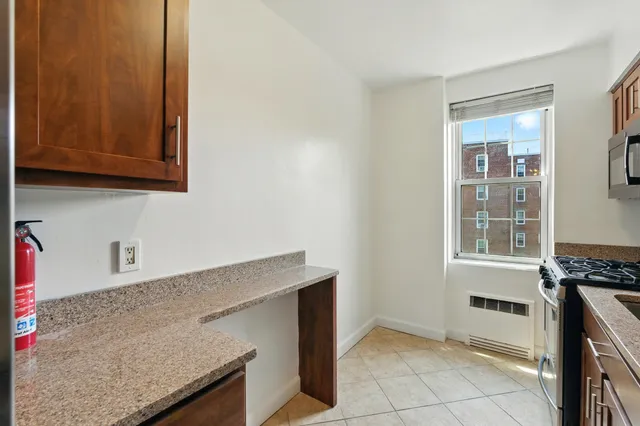 a kitchen with granite countertop a sink and a stove