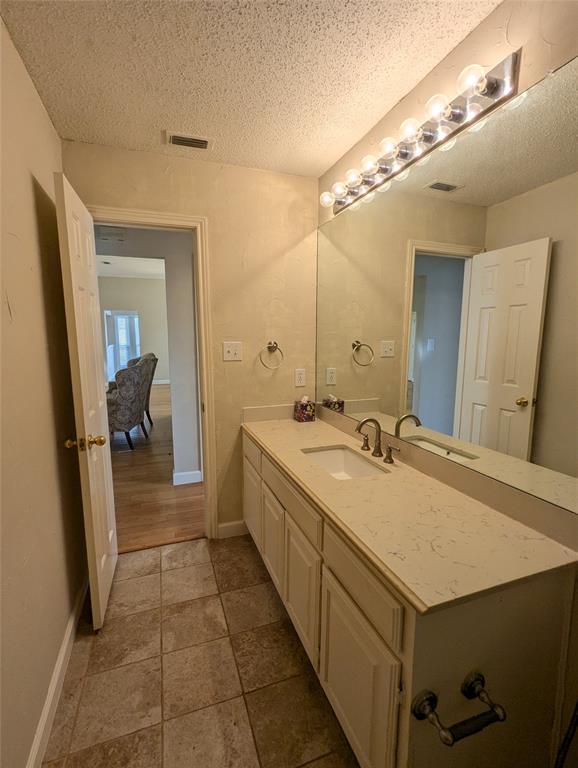 6019 Mapleshade Lane Dallas, TX 75252 - Photo 8 of 14 a bathroom with a sink and a mirror