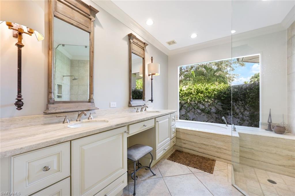 3960 Deep Passage Way Naples, FL 34109 - Photo 22 of 34 Well-appointed bathroom with luxury and practicality. Features spacious, separate shower and soaking tub. Double vanity provides ample counter space. Privacy picture window allows natural light.