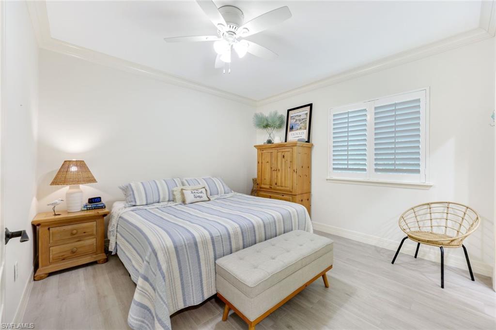 3960 Deep Passage Way Naples, FL 34109 - Photo 23 of 34 Bedroom with crown molding, wood finished floors, and a ceiling fan