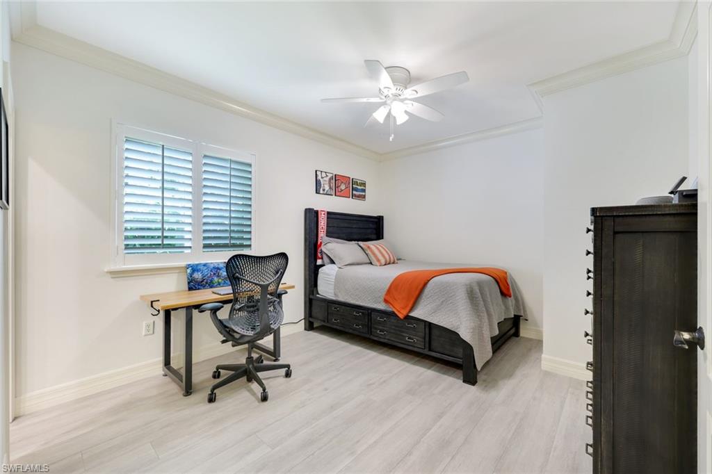 3960 Deep Passage Way Naples, FL 34109 - Photo 27 of 34 Bedroom with crown molding, light wood finished floors and a ceiling fan.