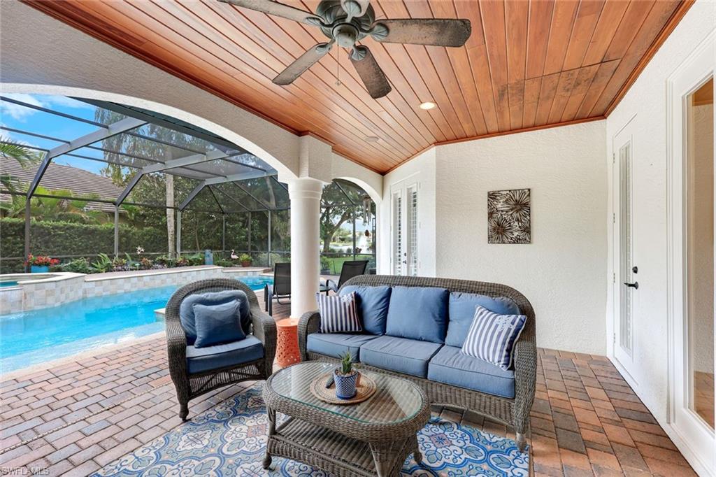 3960 Deep Passage Way Naples, FL 34109 - Photo 4 of 34 Relaxing outdoor space featuring a well-maintained paver stone pool deck complemented by a charming wood ceiling structure, ideal for enjoying sunny days and cool evenings by the pool.