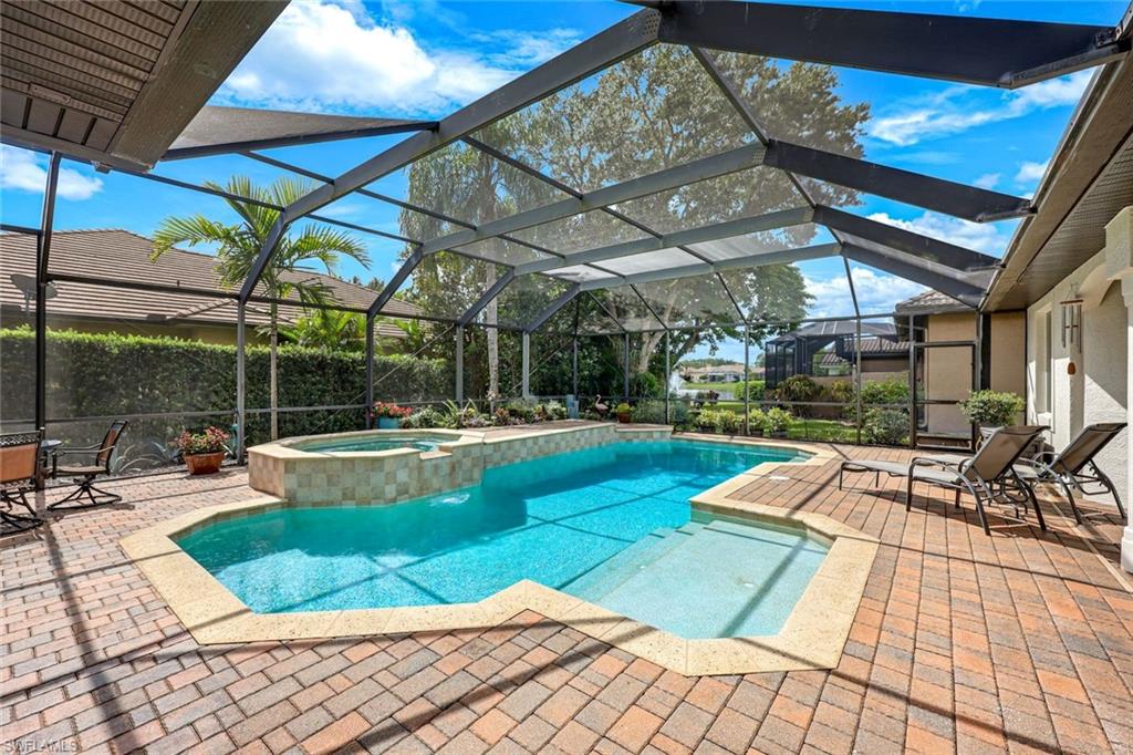 3960 Deep Passage Way Naples, FL 34109 - Photo 5 of 34 Enjoy the beautiful paver pool deck, relax in the heated salt water pool, and unwind in the comfortable screened-in lanai, perfect for outdoor enjoyment and relaxation.