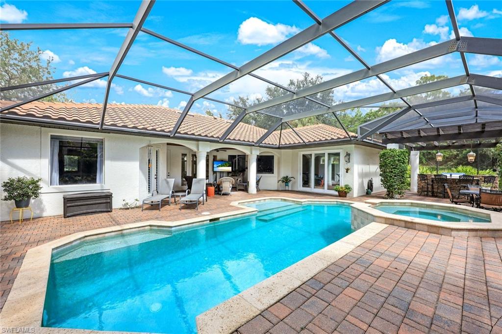 3960 Deep Passage Way Naples, FL 34109 - Photo 8 of 34 Property features a beautifully maintained heated swimming pool, perfect for relaxation and recreation, complemented by a relaxing spa