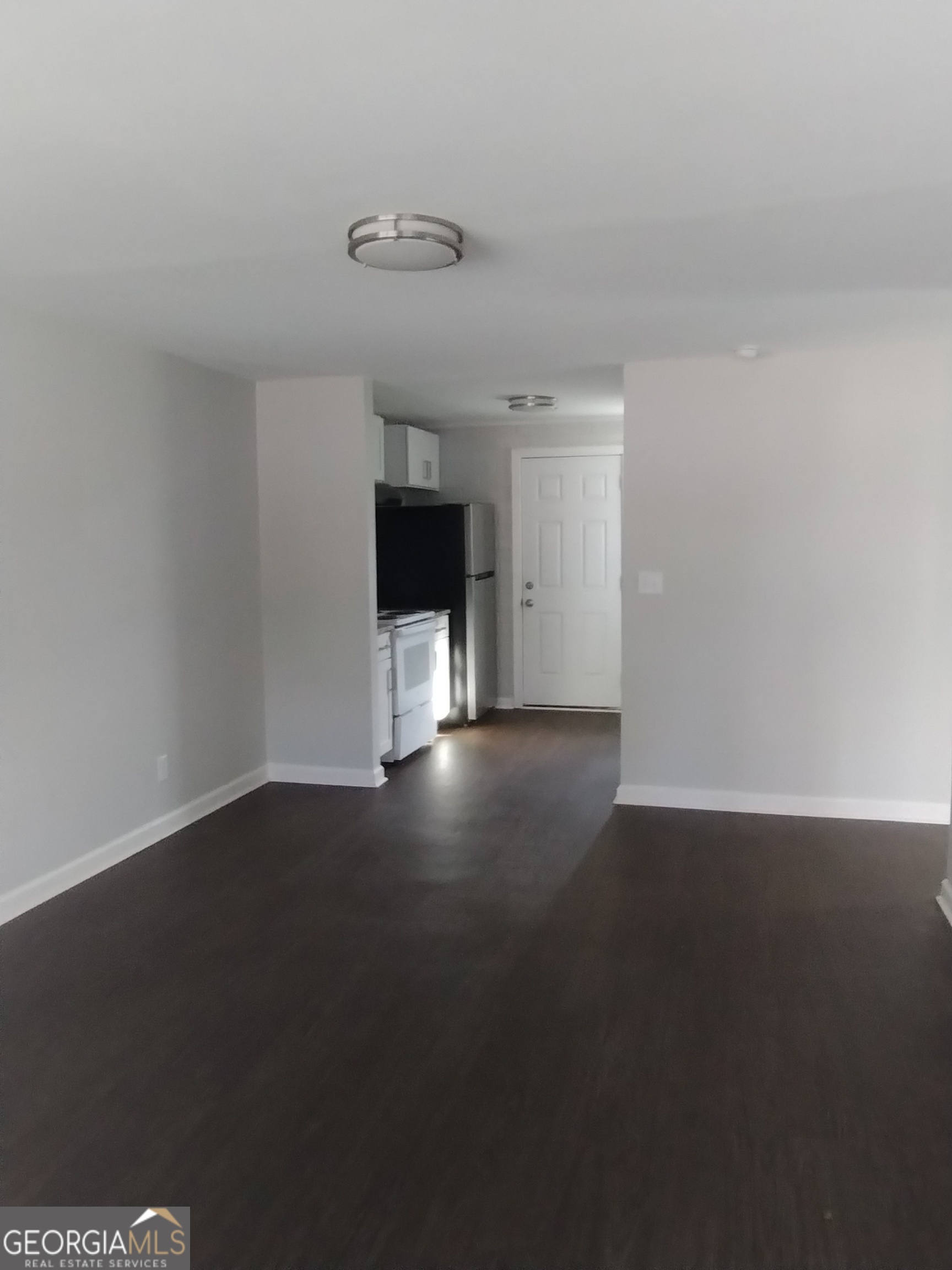 1112 Carroll Street Macon, GA 31206 - Photo 5 of 5 a view of an empty room with wooden floor and a fireplace
