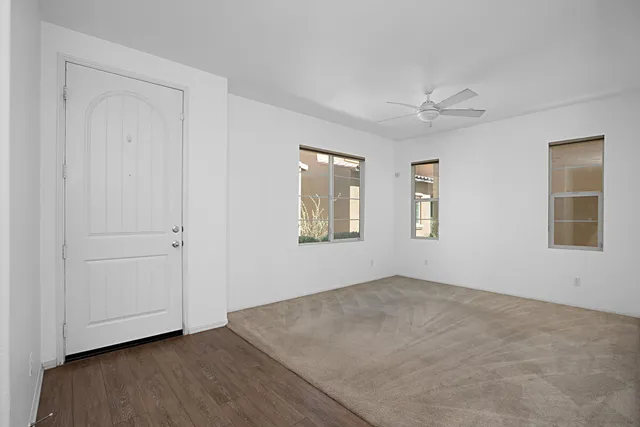 an empty room with windows and closet