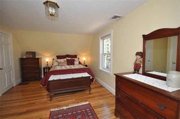 34 Valleyfield Street Lexington, MA 02421 - Photo 9 of 13 a bedroom with a bed and wooden floor